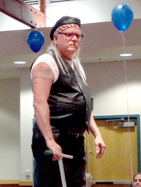 Cliff Kauffman, director of retail for Goodwill of the Southern Alleghenies, dons biker gear for a fashion show Wednesday during Goodwill’s Report to the Community gathering at Pitt-Johnstown’s Living Learning Center.