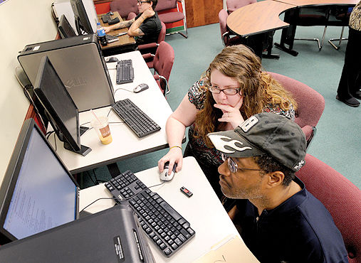 Goodwill Job Center Jen Pfeil, an employment counselor at the Goodwill Career Center, helps Anthony Wiley of Johns­town search for work at a computer station.